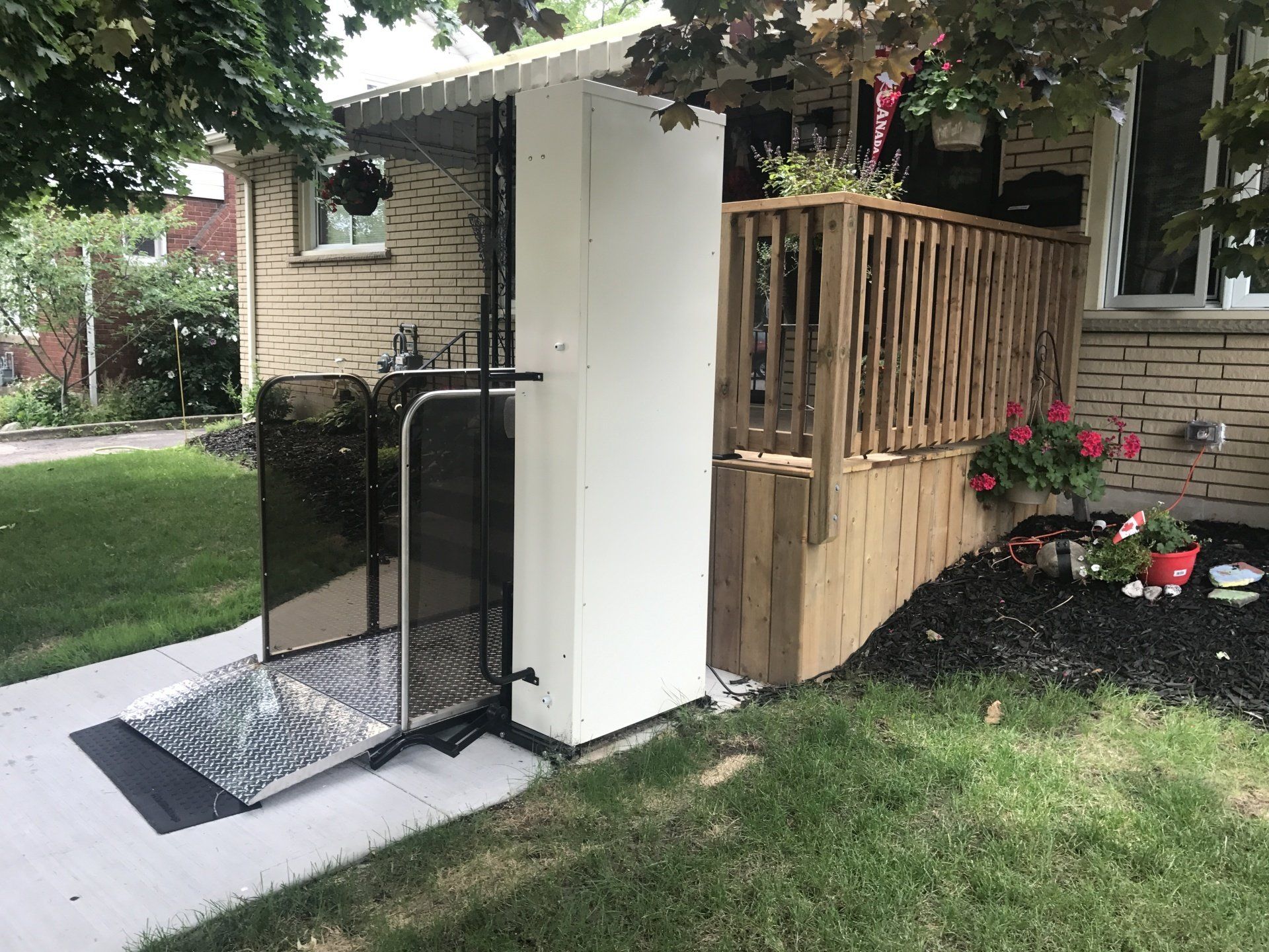 A house with a wheelchair lift in front of it