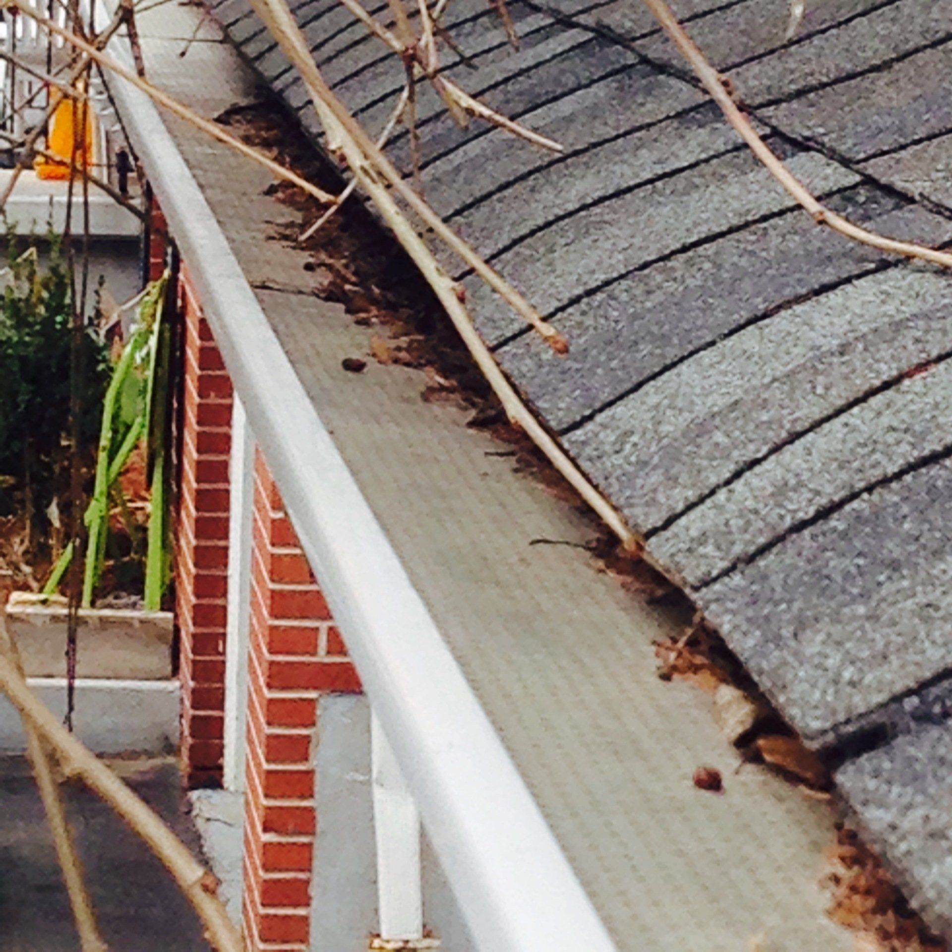 A gutter on the side of a brick building
