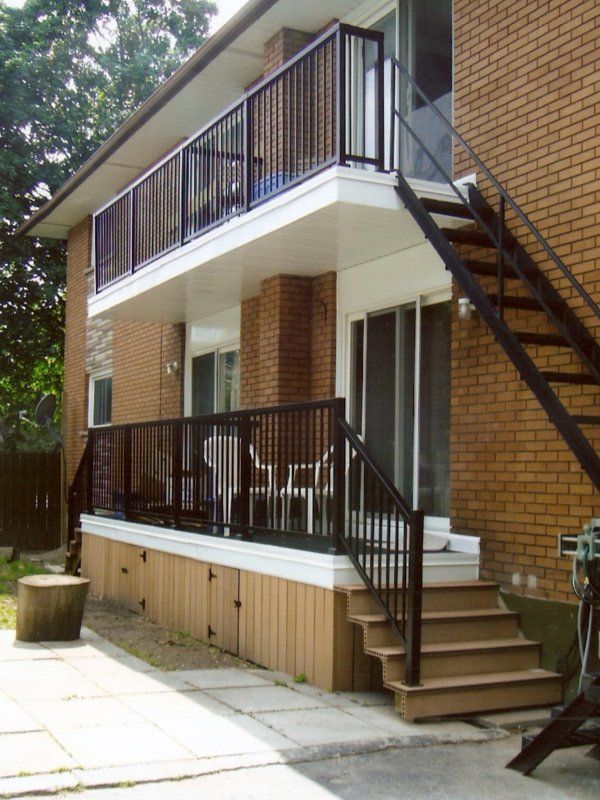A brick building with a balcony and stairs