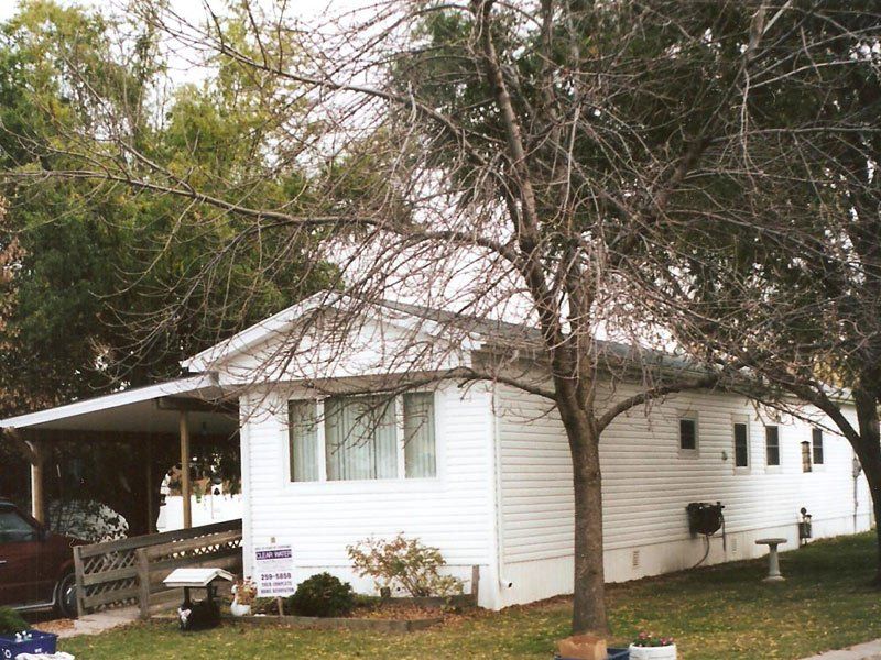 A white house with a for sale sign in front of it