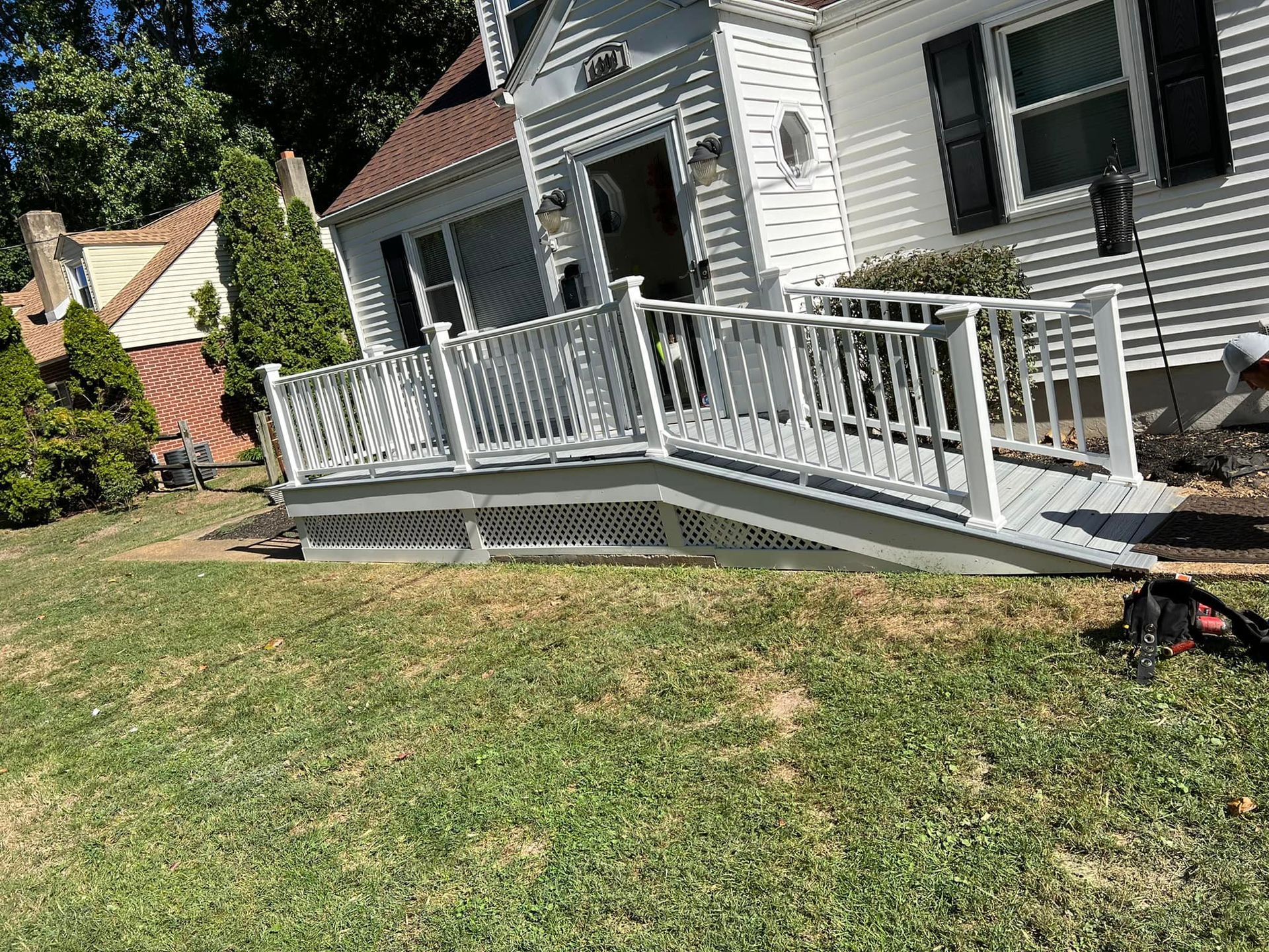 A white house with a ramp in front of it.