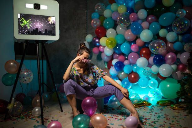 Woman posing by an interactive photo booth kiosk