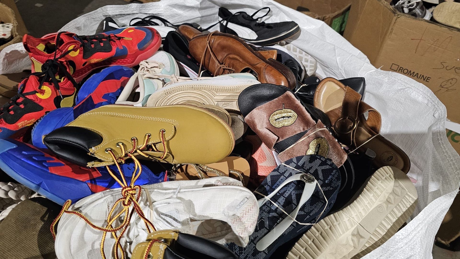A pile of shoes is sitting on top of a table.