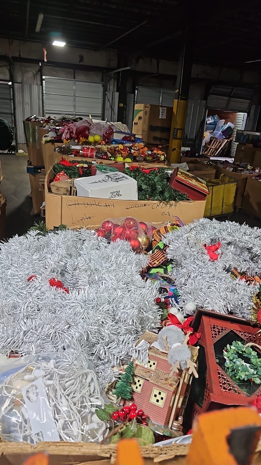 A warehouse filled with lots of christmas decorations and tinsel.
