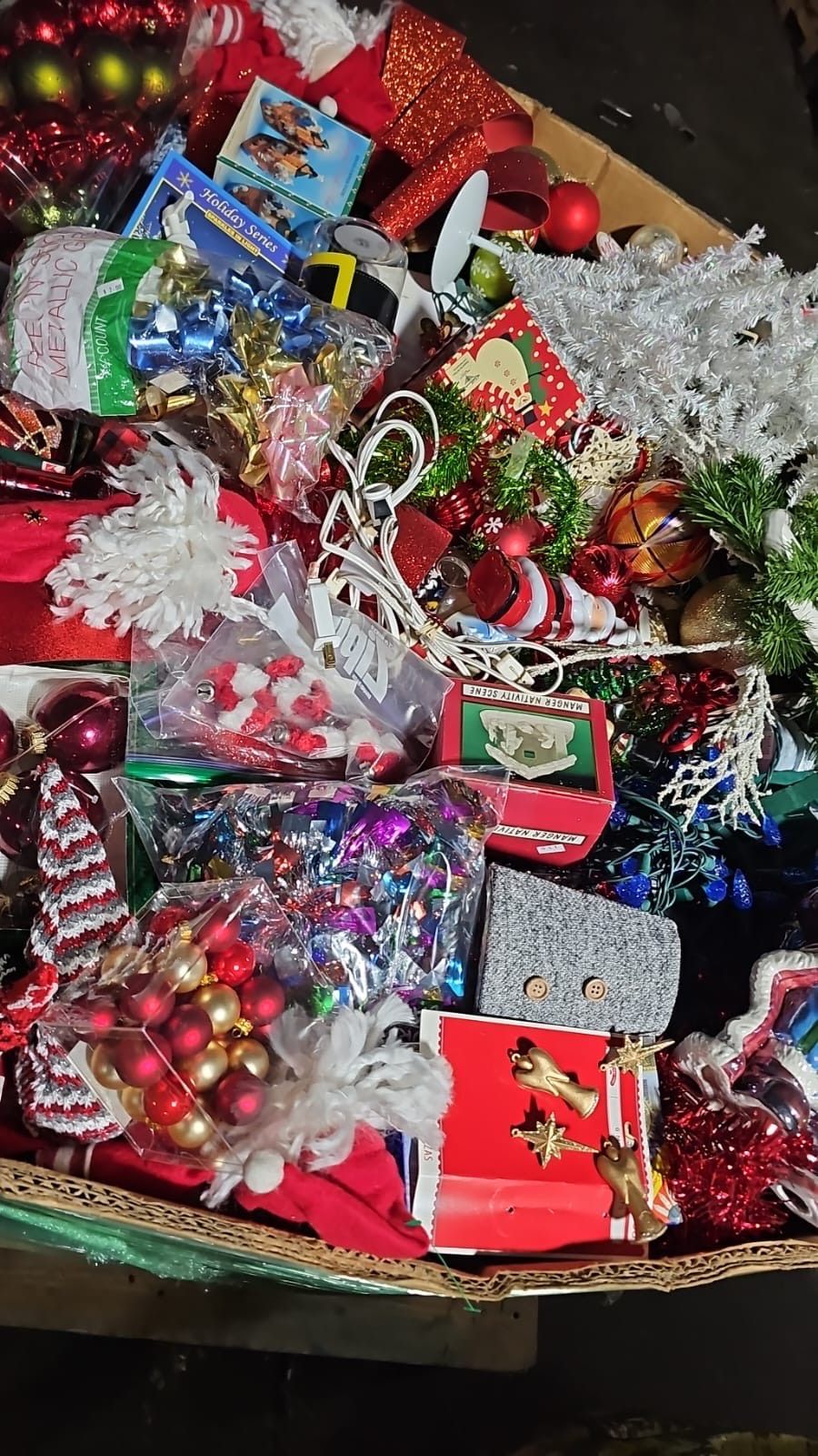 A pile of christmas decorations and gifts on a table.
