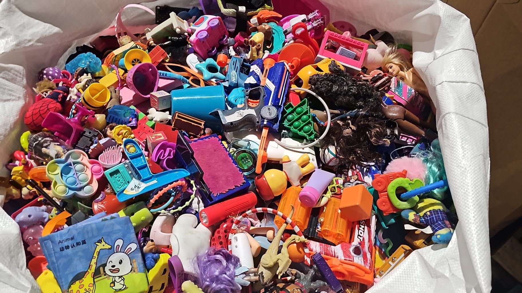 A pile of colorful toys in a white bag
