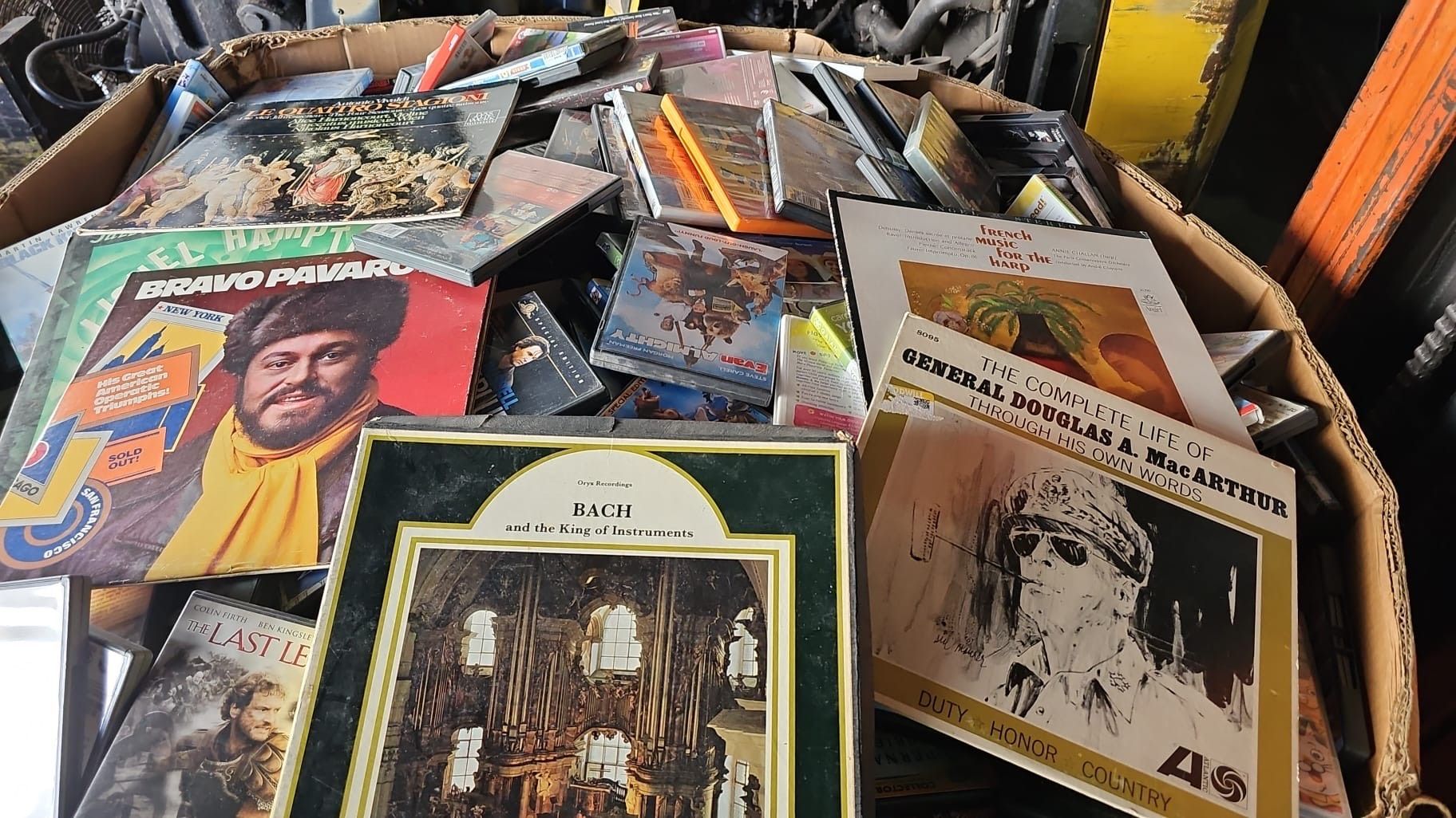 A cardboard box filled with a lot of cds