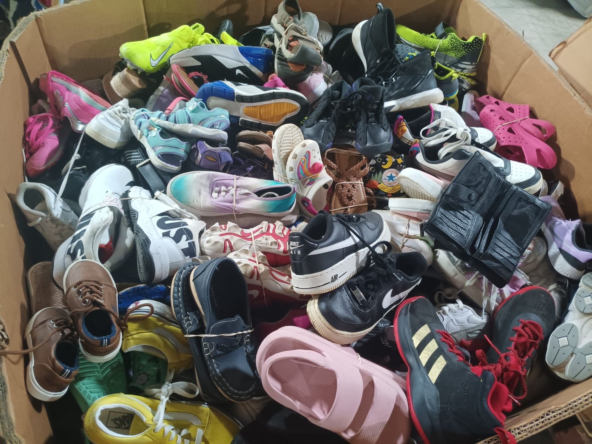 A box filled with lots of different types of shoes.