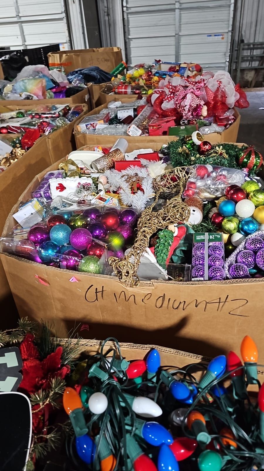 A bunch of boxes filled with christmas decorations and lights.