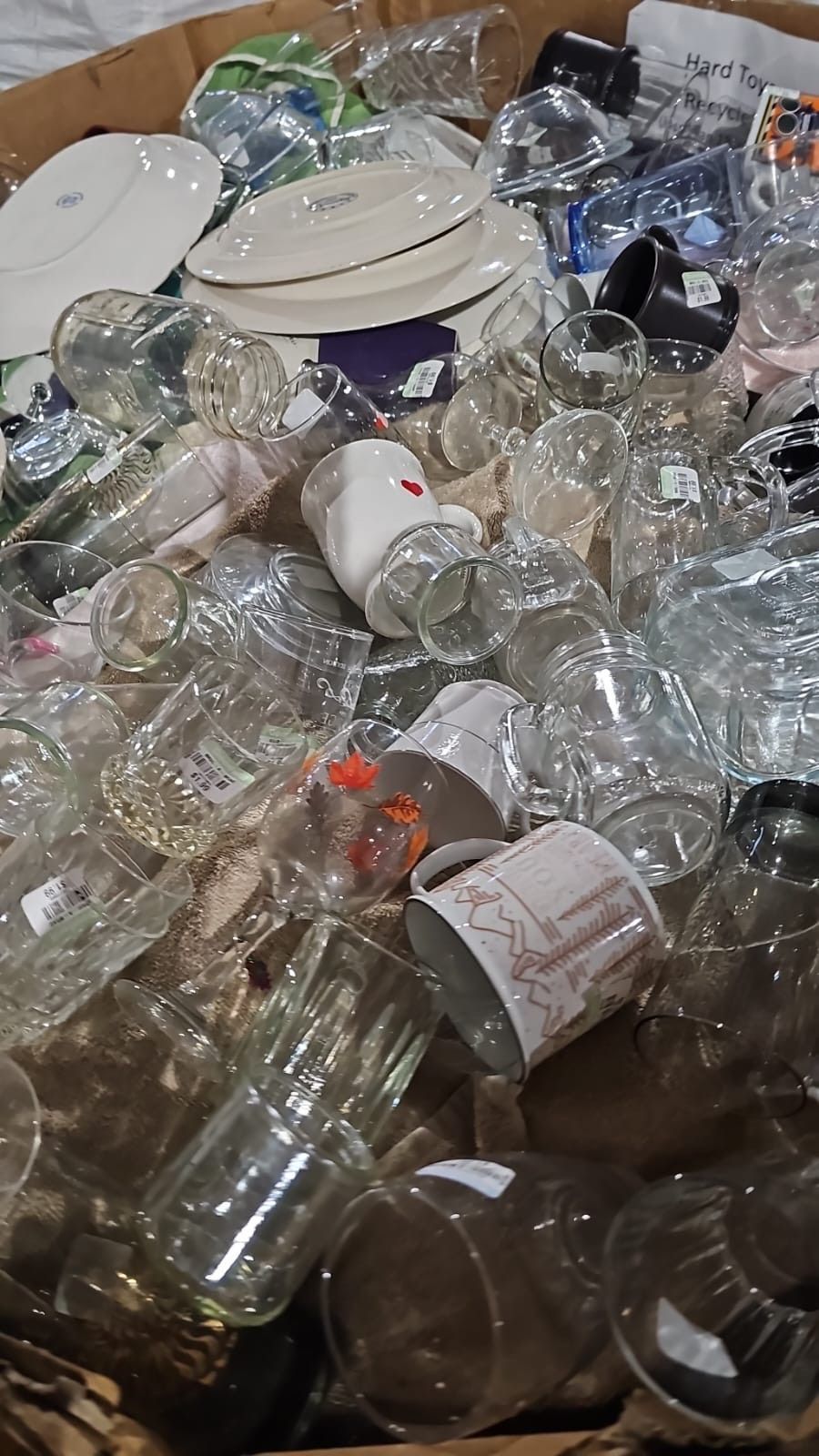 A box filled with lots of empty glasses and cups.