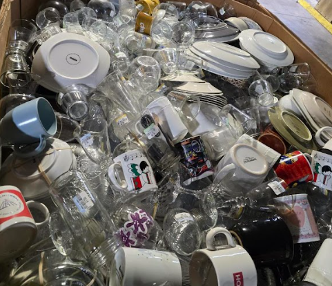 A box filled with a lot of broken glasses and cups