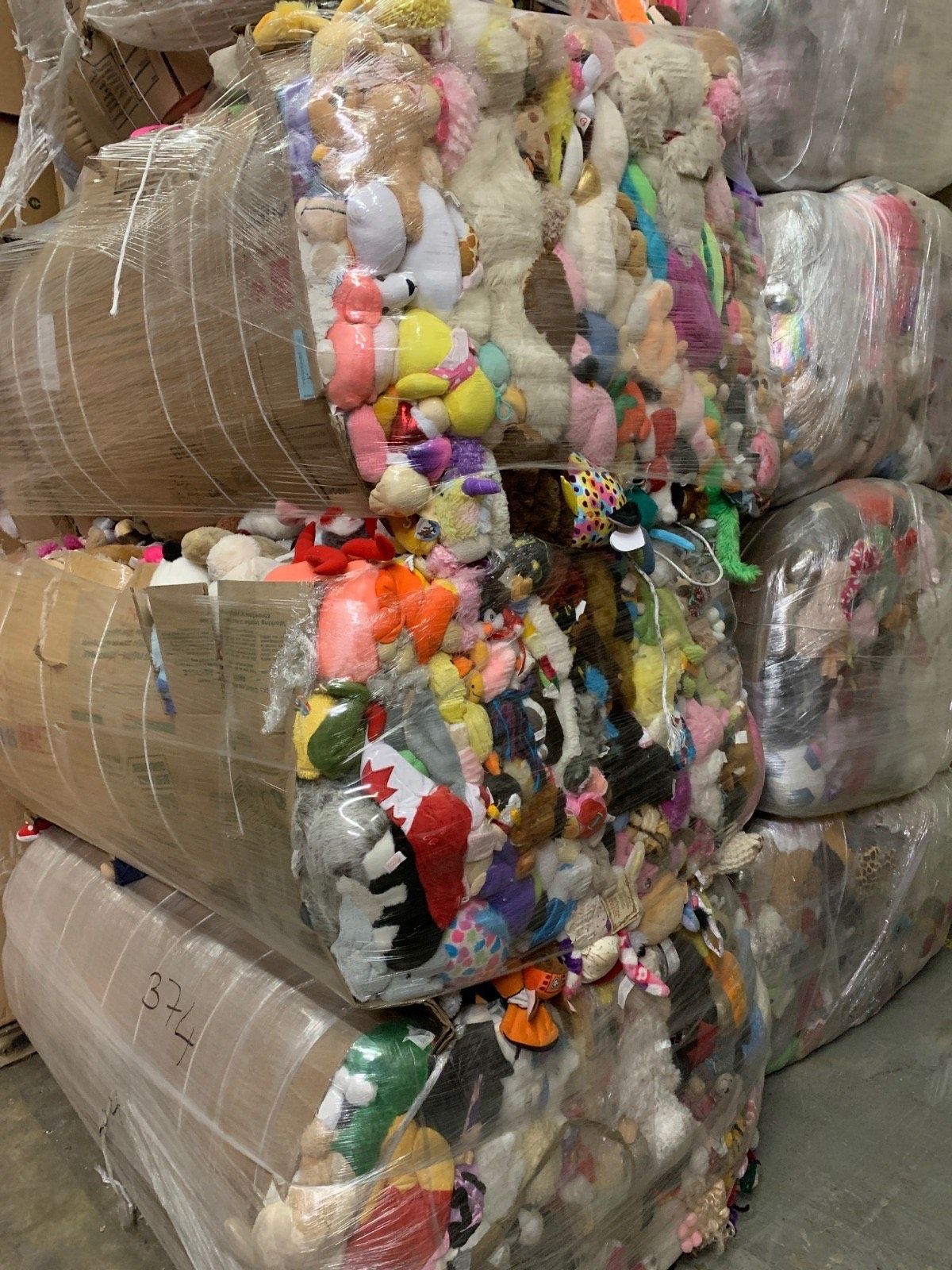 A pile of stuffed animals stacked on top of each other.