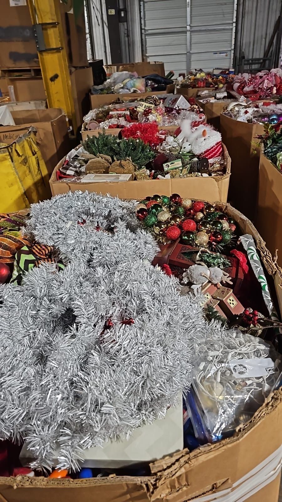A warehouse filled with lots of christmas decorations and tinsel.