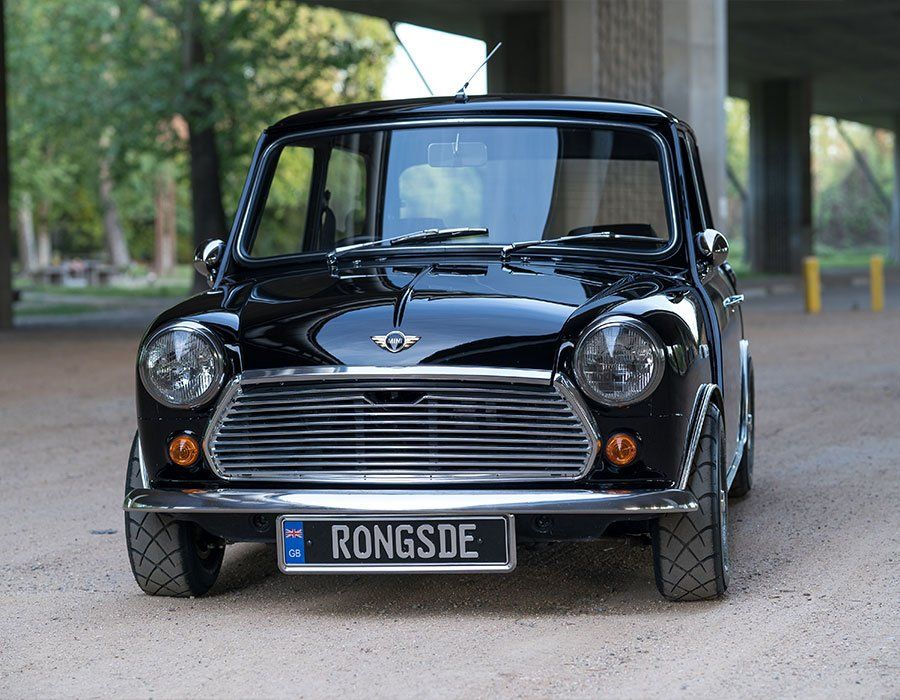 A black car with a license plate that says rongsde