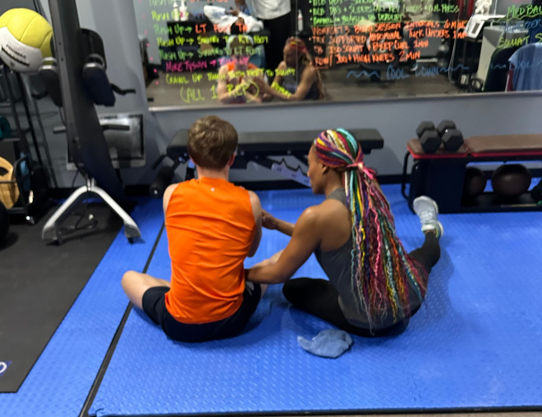 Physiotherapist stretching a patient's leg on an examination table in a clinic.