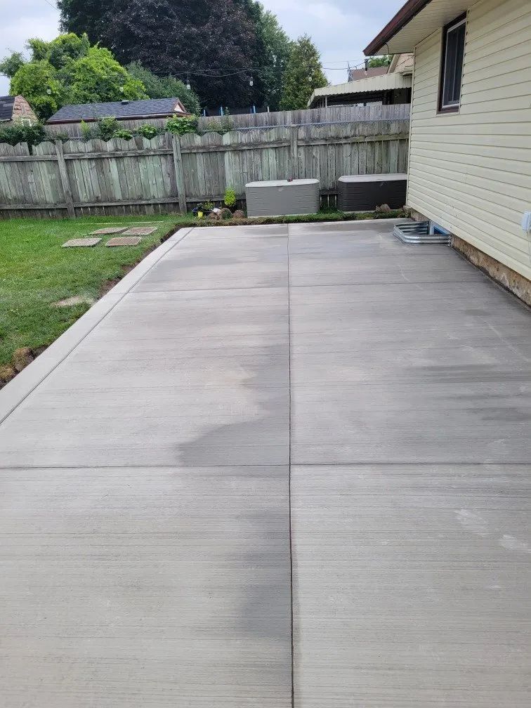 This smooth, broom-finished concrete patio was installed by Stratford Concrete right alongside a residential home — a clean, durable solution for Ontario homeowners looking to maximize their backyard space. Contact us for a free quote.