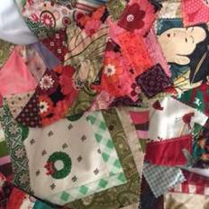 A close up of a quilt with a wreath on it