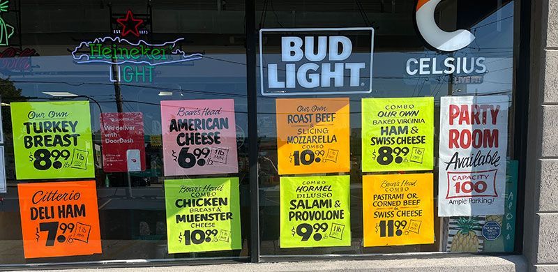 Cold Cut specials on colorful signs through the window