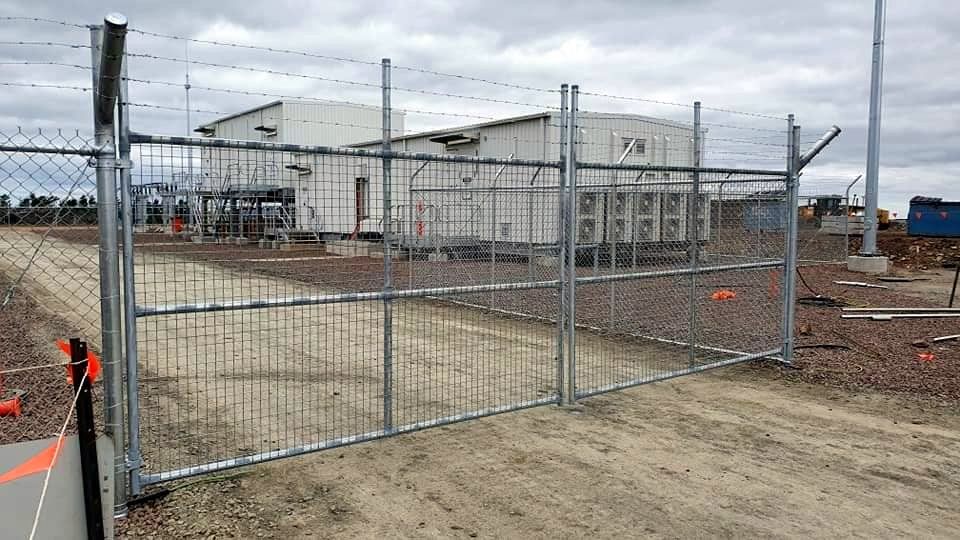 A White Building With a Chain Link Fence Around It — Ettles Rural Fencing in Alfredton, VIC