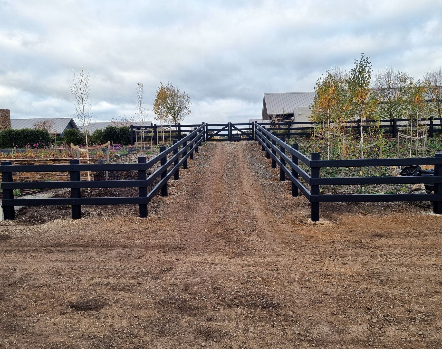 A Wooden Fence Surrounds a House in the Desert — Ettles Rural Fencing in Alfredton, VIC