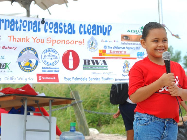 Young girl speaking into a microphone at an International Coastal Cleanup event.
