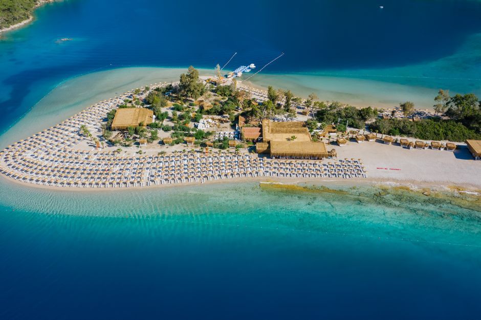 Tips for visiting Blue Lagoon Island Bahamas: beach lounger by the turquoise lagoon
