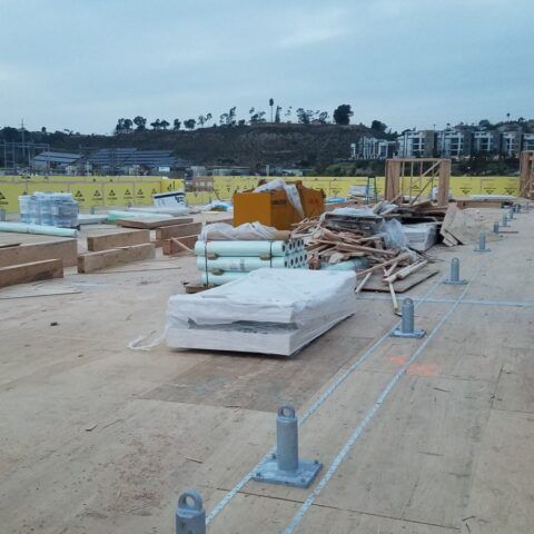 A construction site with a lot of supplies on the ground