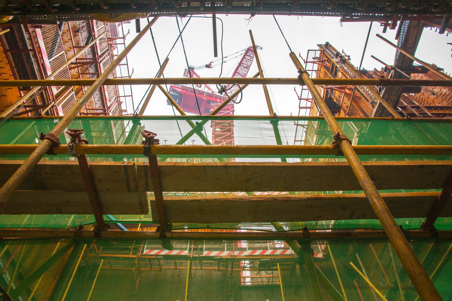 Looking up at a building under construction with scaffolding