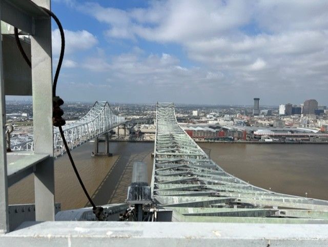 A bridge over a body of water with a city in the background