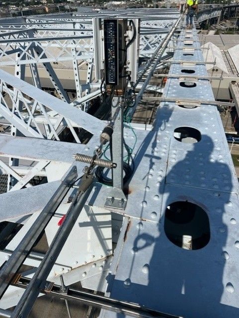 A shadow of a person is cast on a metal structure