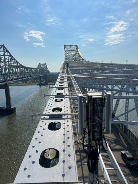 A bridge over a body of water with a blue sky in the background