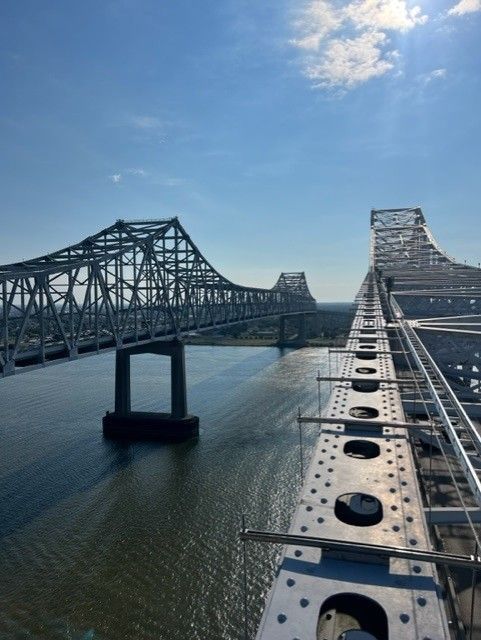 A bridge over a body of water with a blue sky in the background