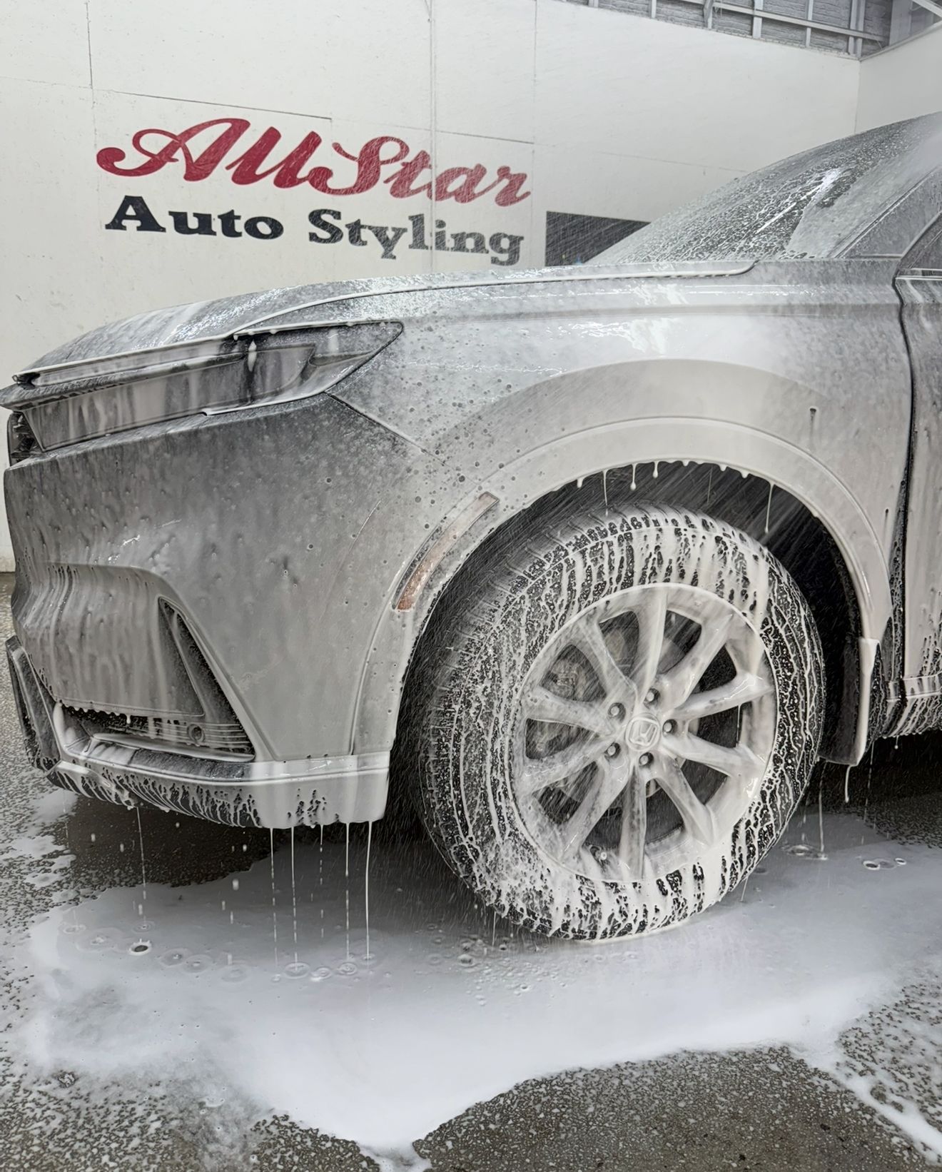 Car covered in foamy soap at AllStar Auto Styling.