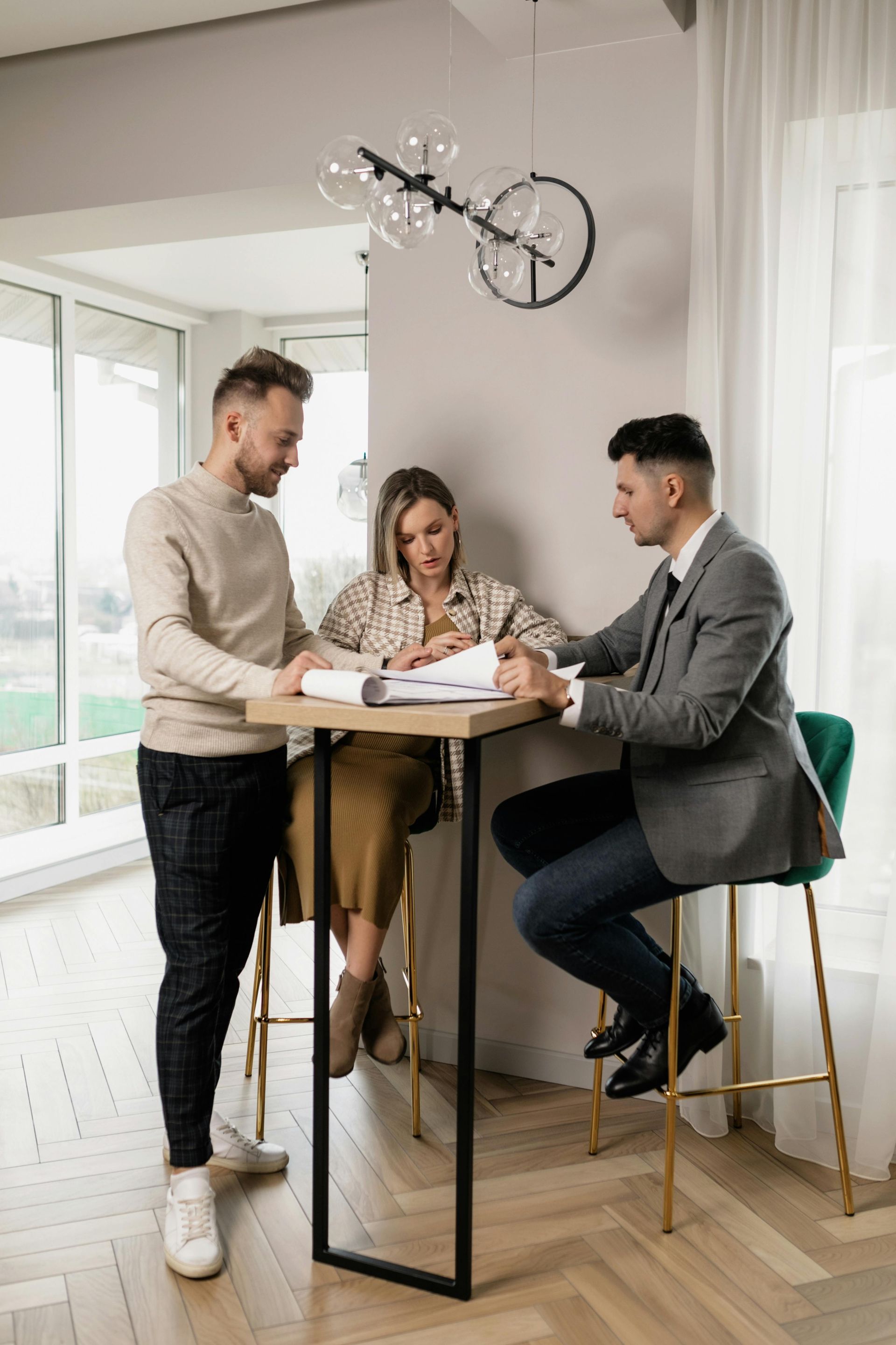 Two business professionals in suits reviewing documents, discussing strategy.