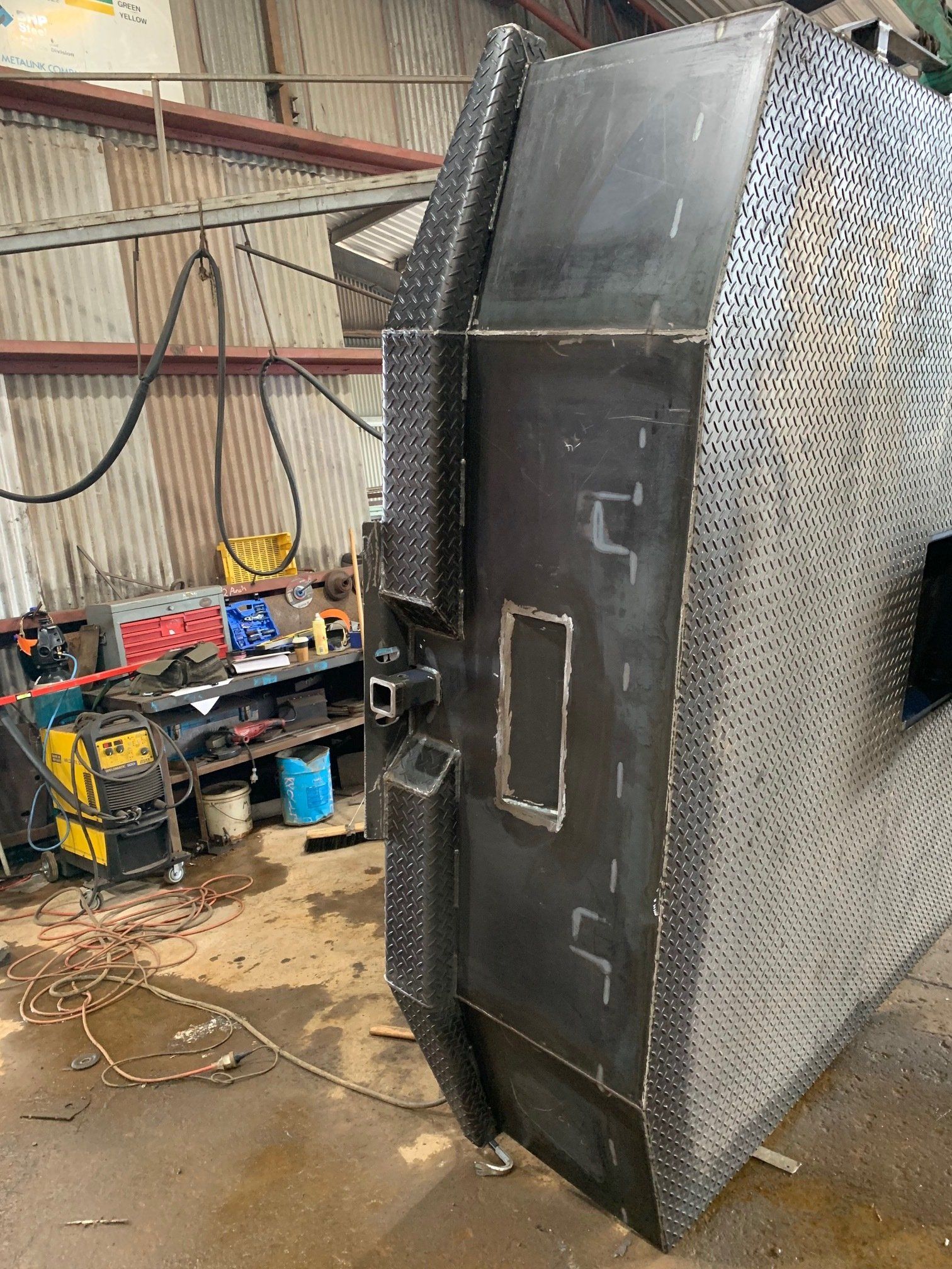 A large piece of metal is sitting in a warehouse.