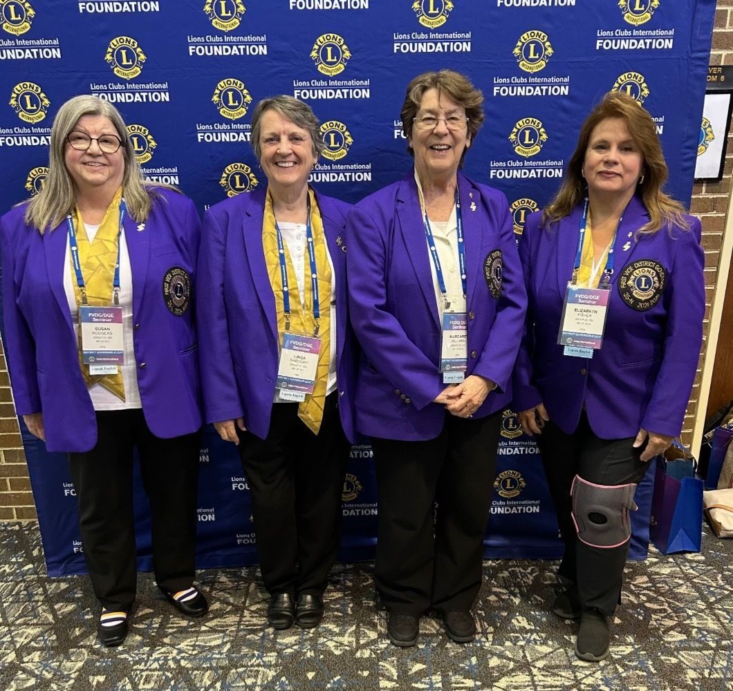 A group of people standing in front of a fountain