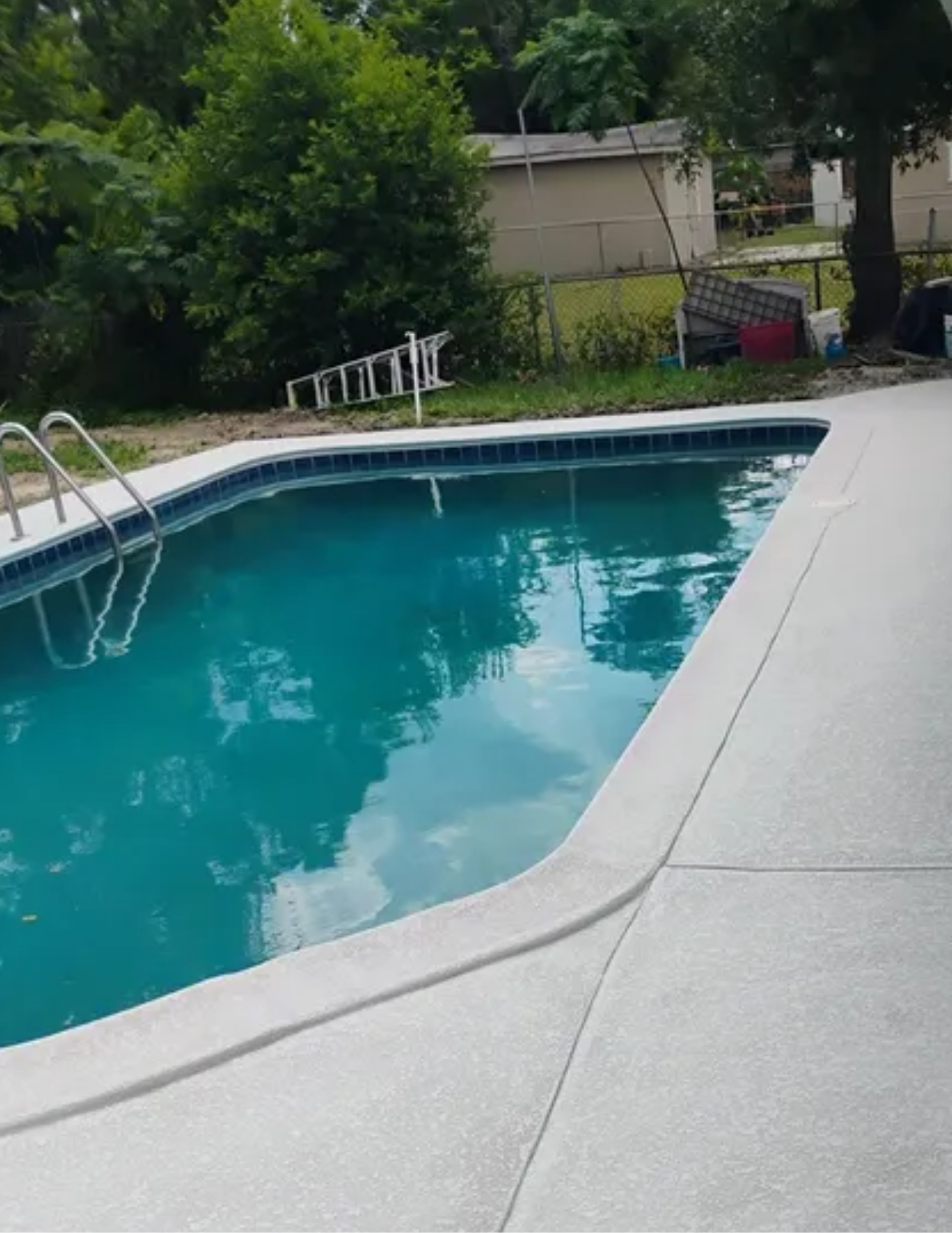 A man is driving an excavator in a dirt field