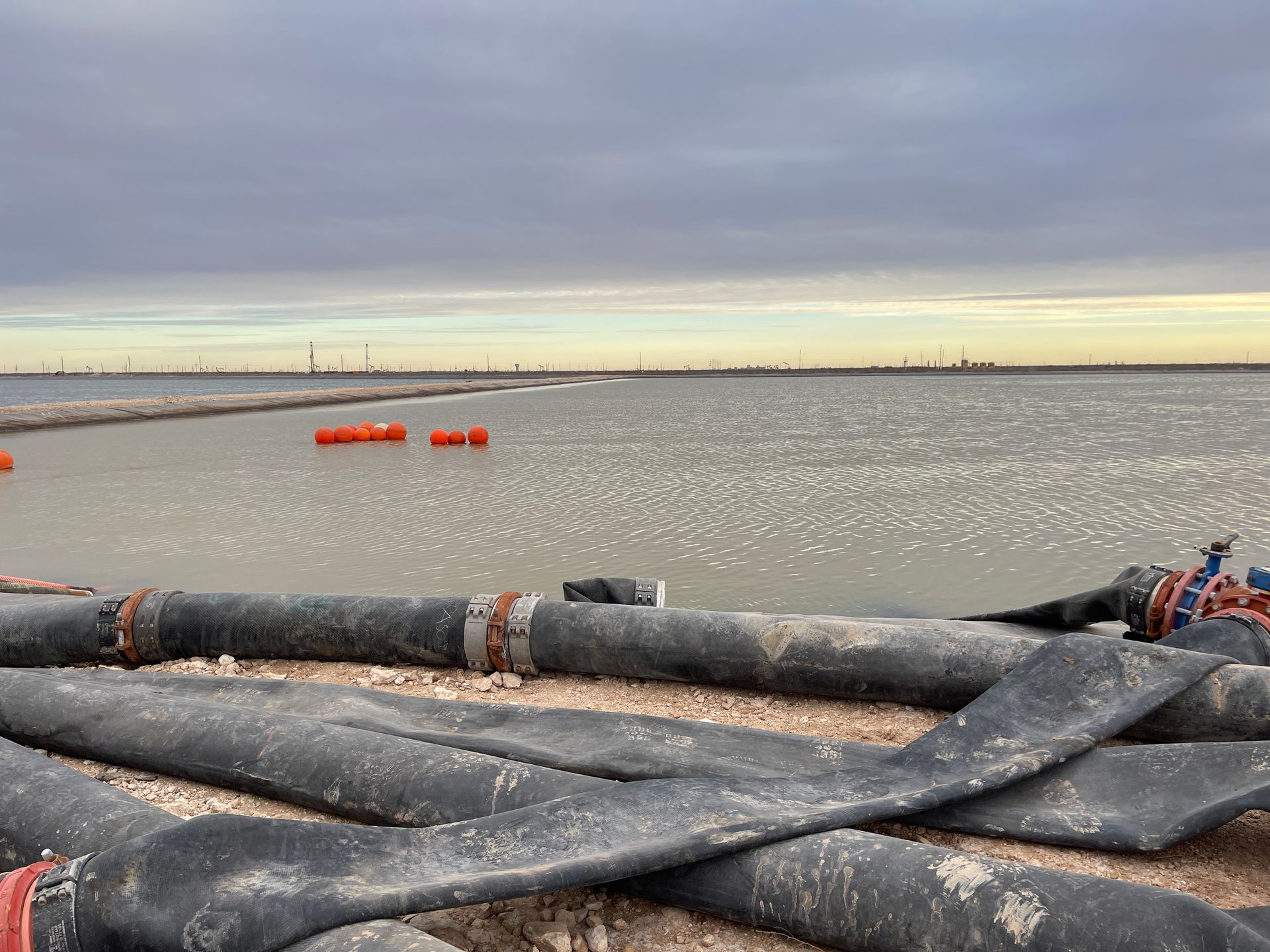 a Pesco employee wearing a welding mask is welding a pipe