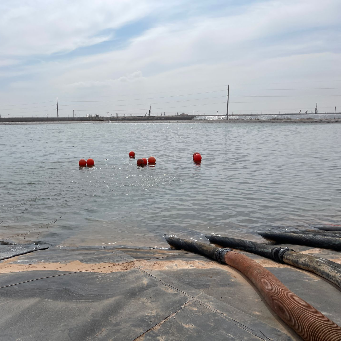 a Pesco employee wearing a welding mask is welding a pipe