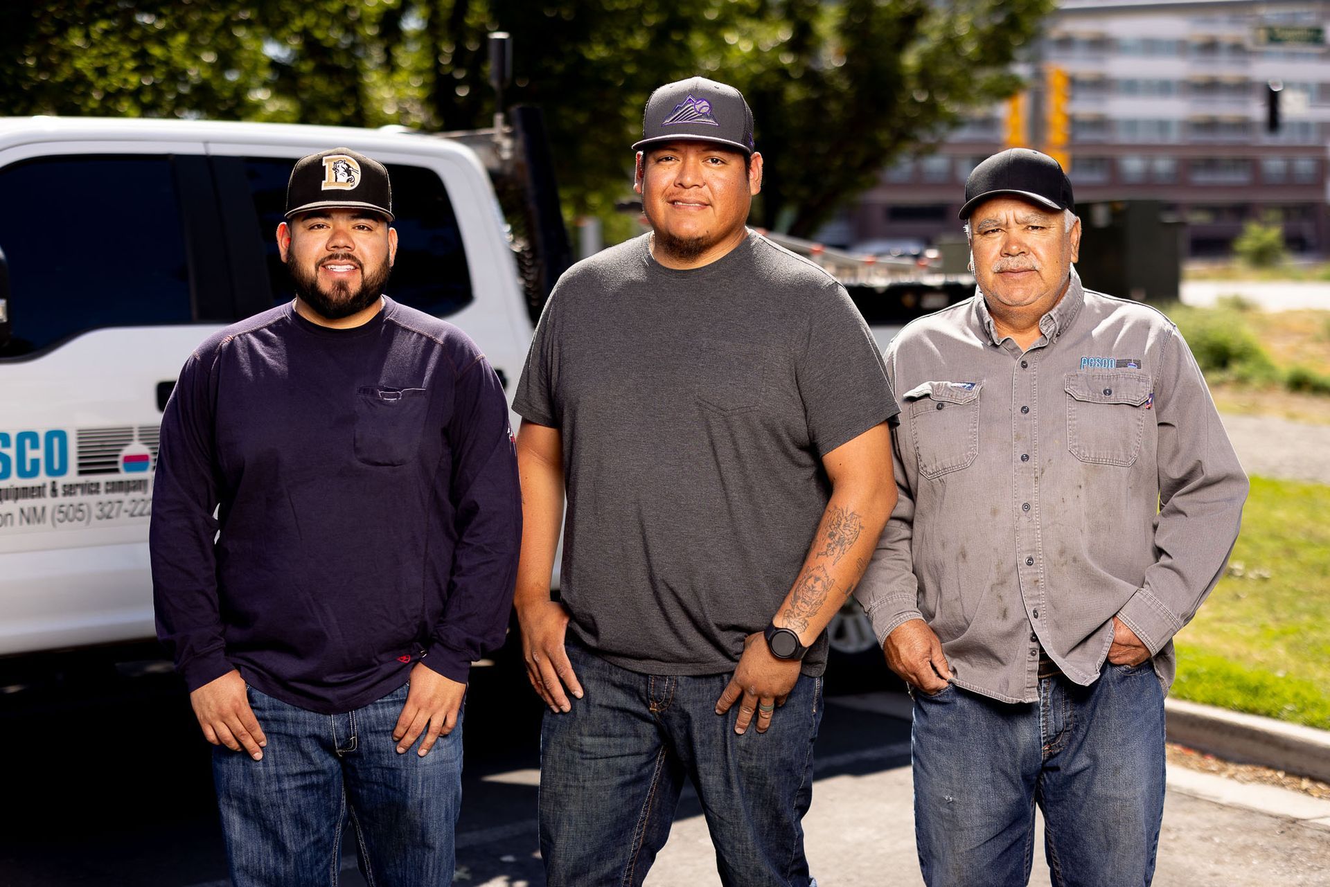 a PESCO employee wearing a hat and ear buds is working on a pipe