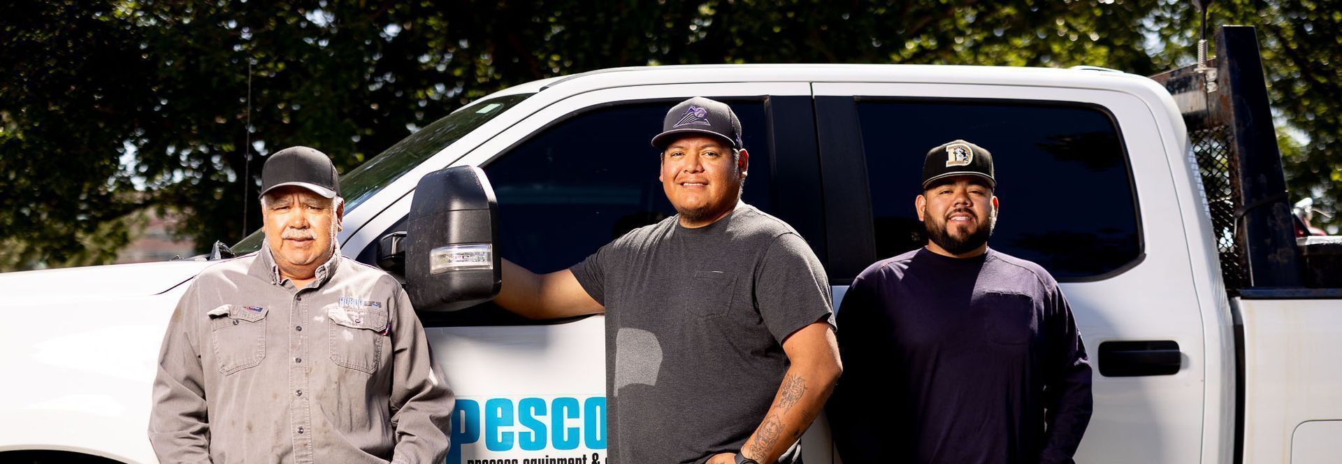 Pesco Denver field service team are standing in front of a white Pesco truck.