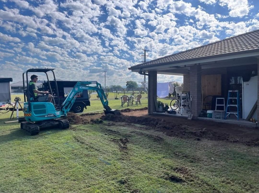Two Men Are Painting A Wall In A Room — TM Built Construction In Lochinvar, NSW