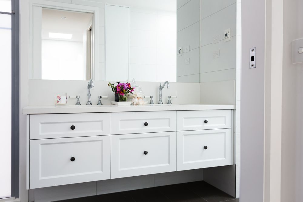 A Bathroom With Two Sinks and White Cabinets — TM Built Construction In Kurri Kurri, NSW