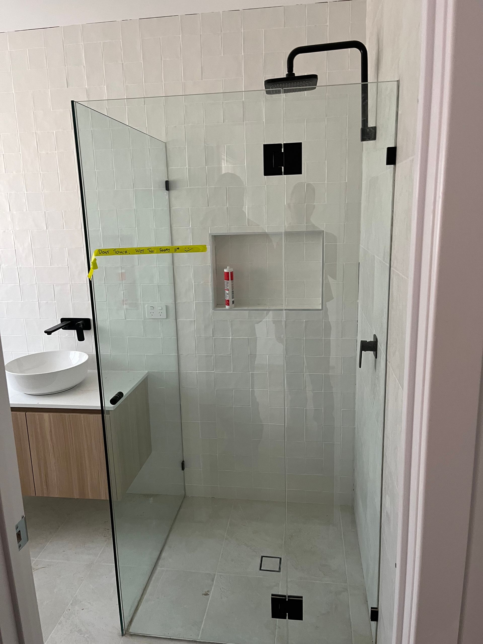 A bathroom with a walk in shower and a sink — TM Built Construction In Lochinvar, NSW