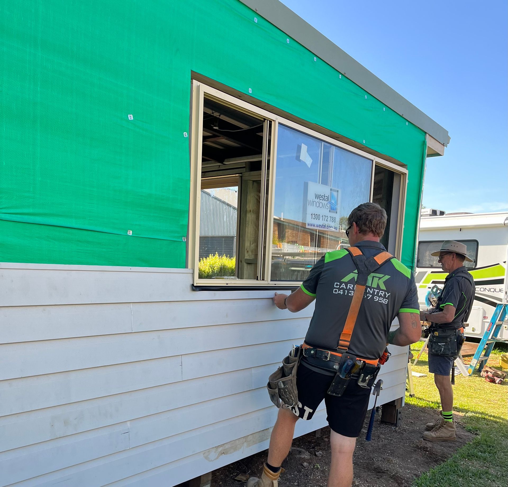 A Person is Sanding a Piece of Wood With a Belt Sander — TM Built Construction In Lochinvar, NSW