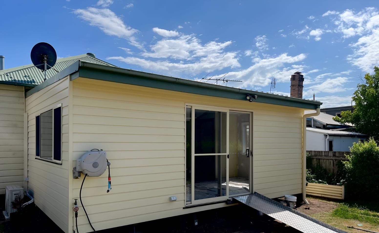 Back of a House With a Ramp and a Satellite Dish — TM Built Construction In Branxton, NSW