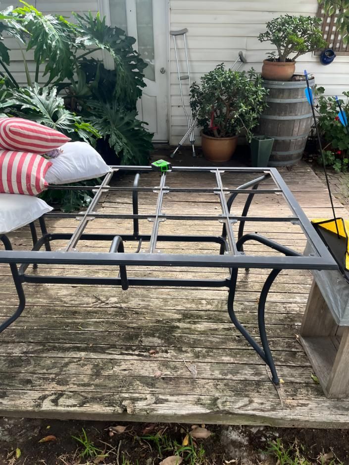 Metal Table Frame is Sitting on a Wooden Deck — TM Built Construction In Branxton, NSW