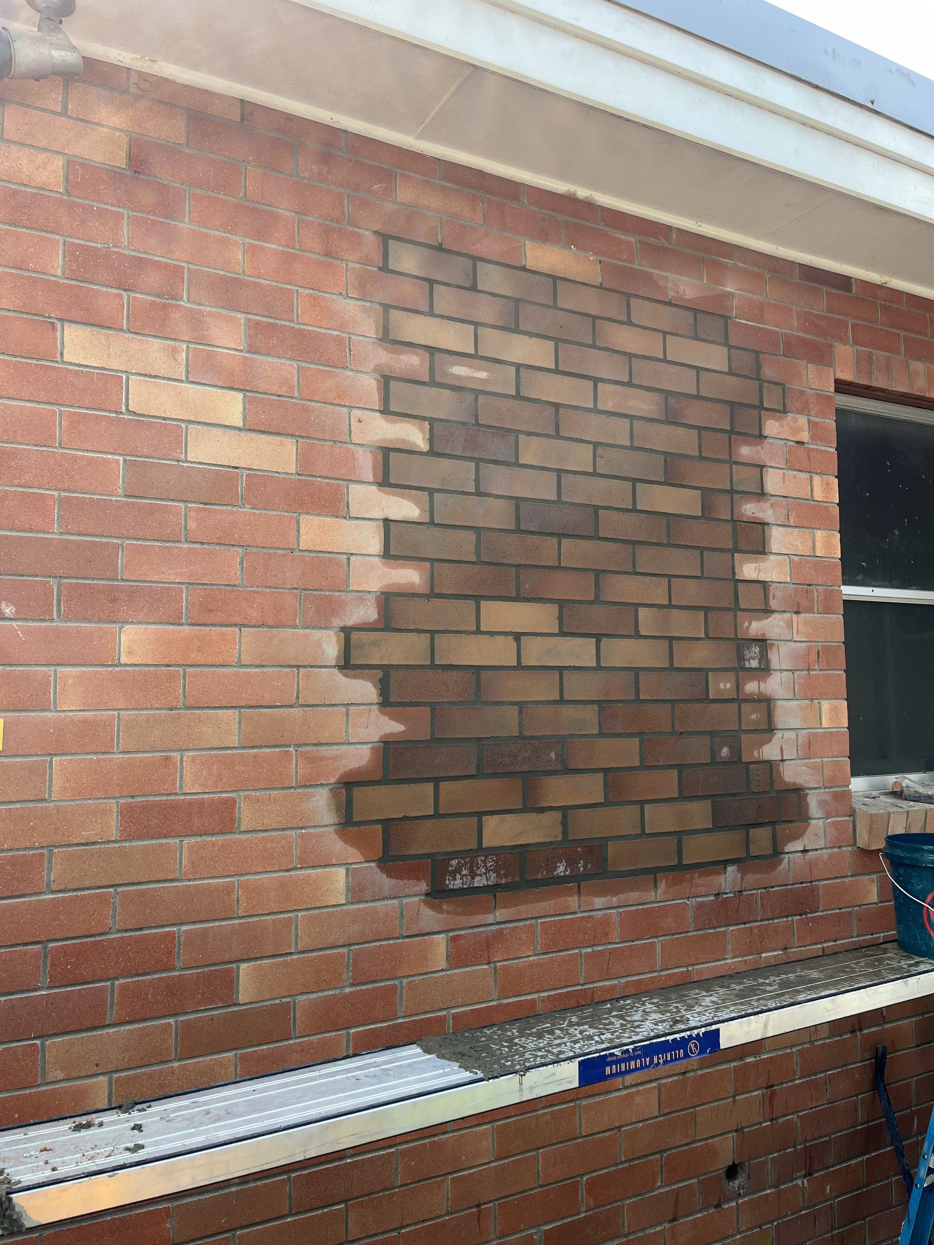 Brick Wall With a Window and a Ladder — TM Built Construction In Maitland, NSW