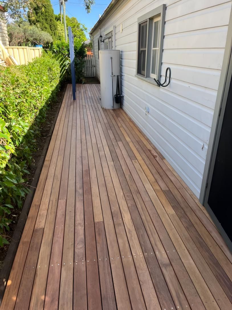 White House With a Wooden Deck in Front of It — TM Built Construction In Cessnock, NSW