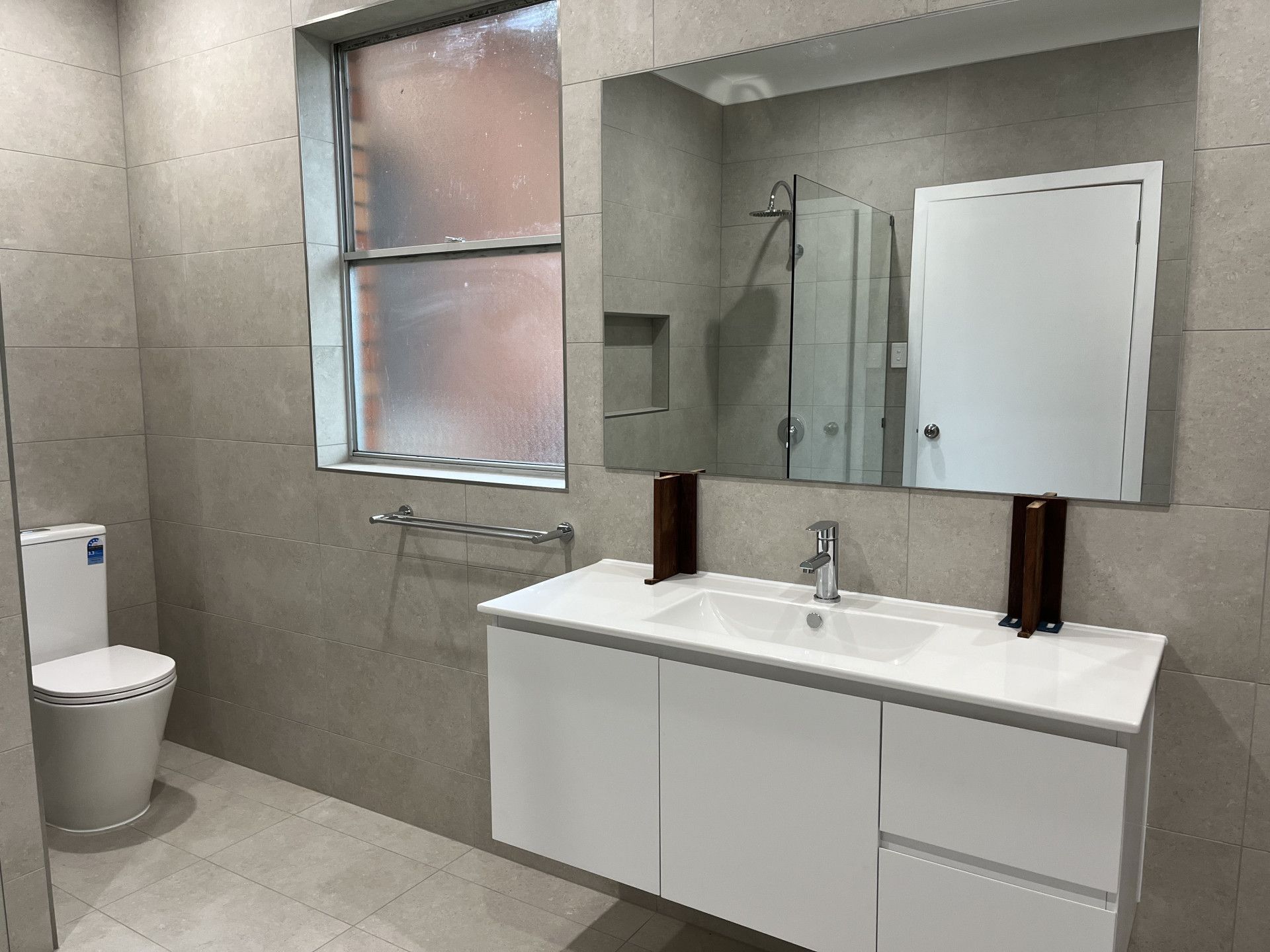A Bathroom With a Bathtub and Mirror — TM Built Construction In Cessnock, NSW